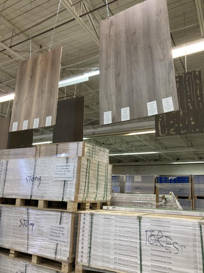 Luxury vinyl plank and laminate flooring samples at Calgary Liquidator
